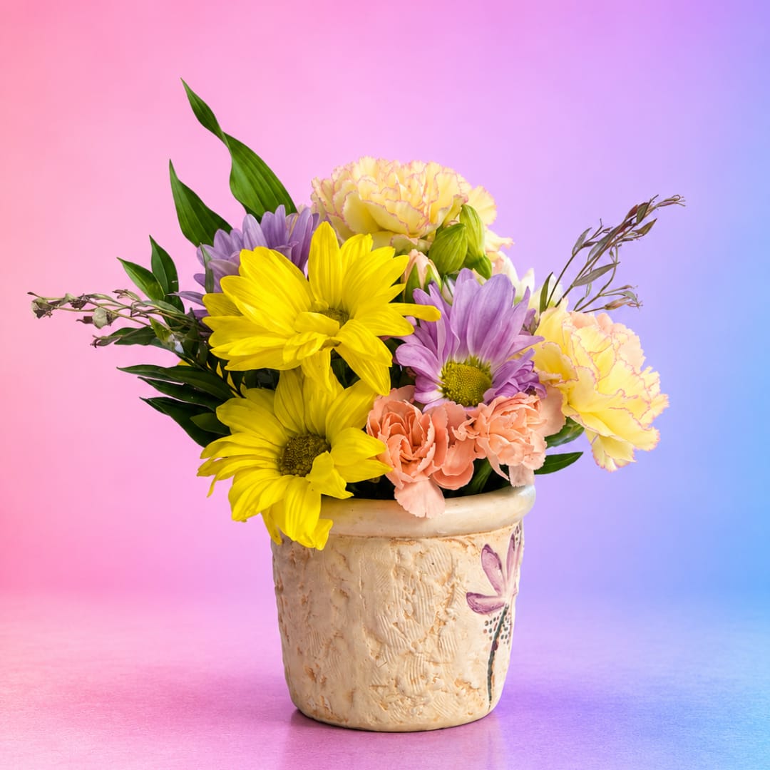 Colorful bouquet of daisies and carnations in a ceramic pot