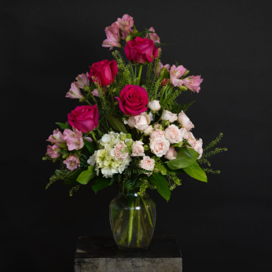 Pink roses and pale alstroemeria in a clear glass vase