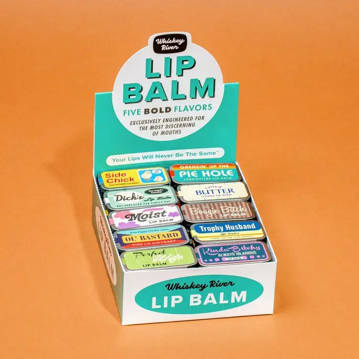 Display box of assorted lip balms on an orange background