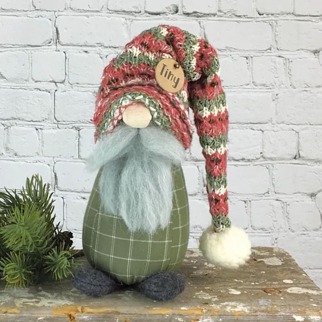 Small gnome figurine with a striped knit hat and fluffy beard