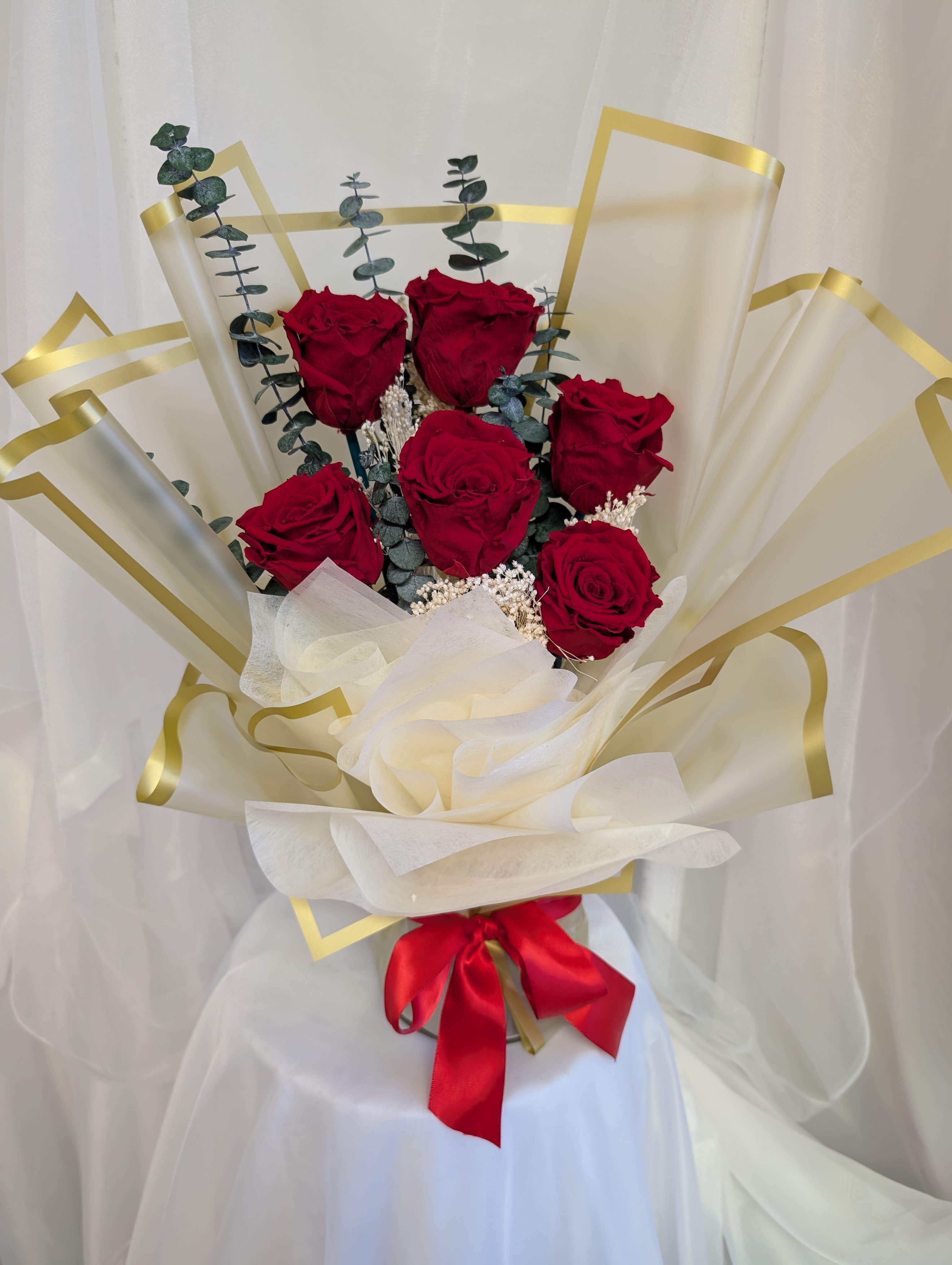 Beauty Dream  - Preserved Florals: Six Red Preserved Roses with preserved Baby's Breath filler and preserved Baby Blue Eucalyptus decorated with elegant golden Koran Paper 