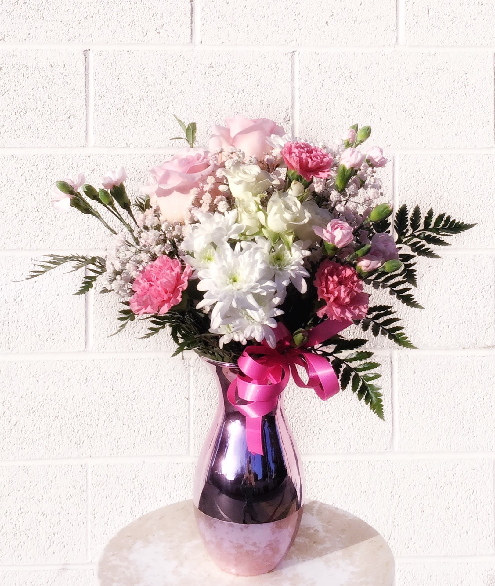 Cotton Candy - Pretty design including white and pastel pink fresh flowers and accents in a reflection vase. STANDARD: FIRST PHOTO DELUXE: SECOND PHOTO