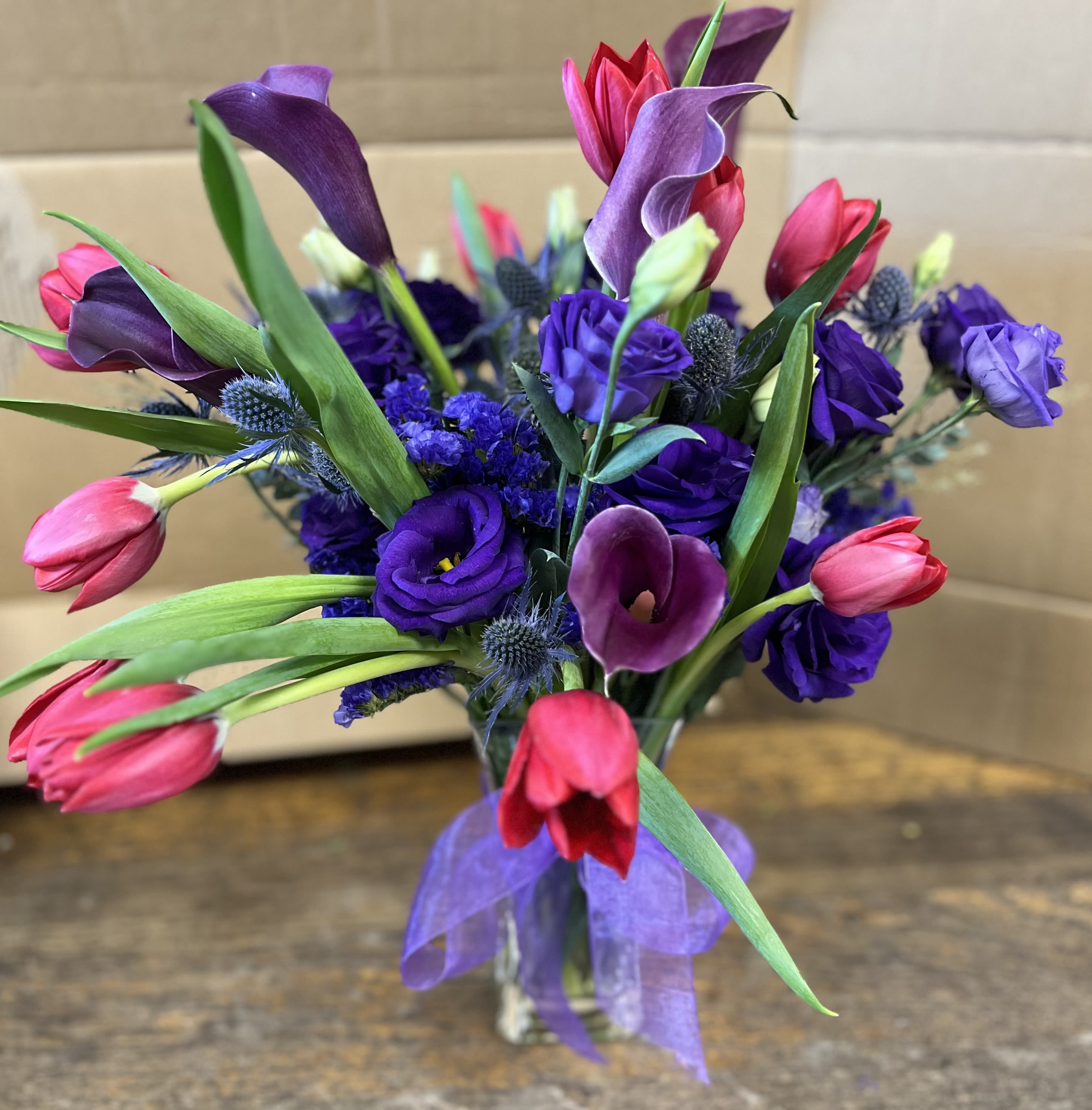 Bouquet of purple and pink flowers in a clear vase