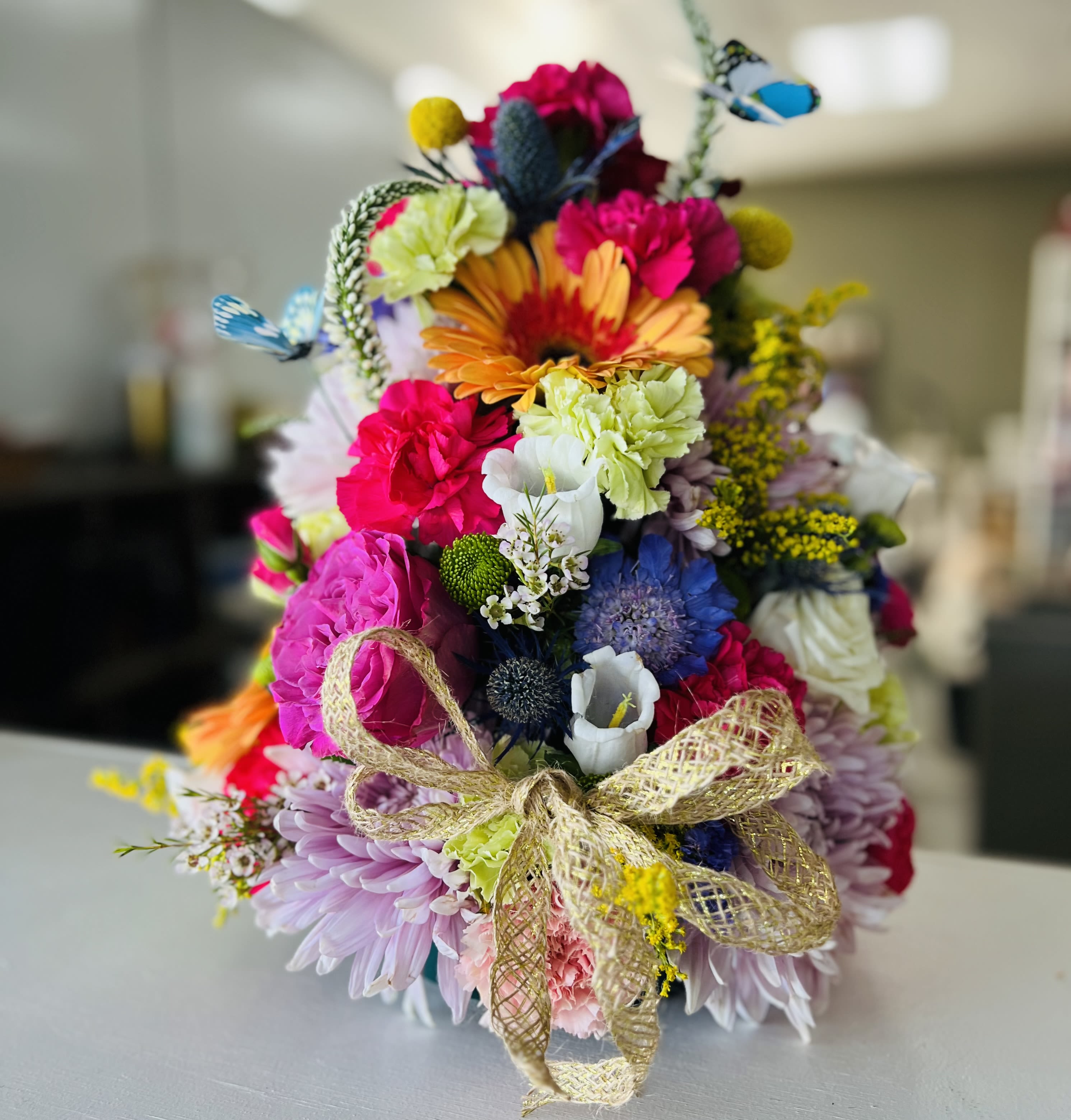 Colorful mixed bouquet with a gold ribbon bow