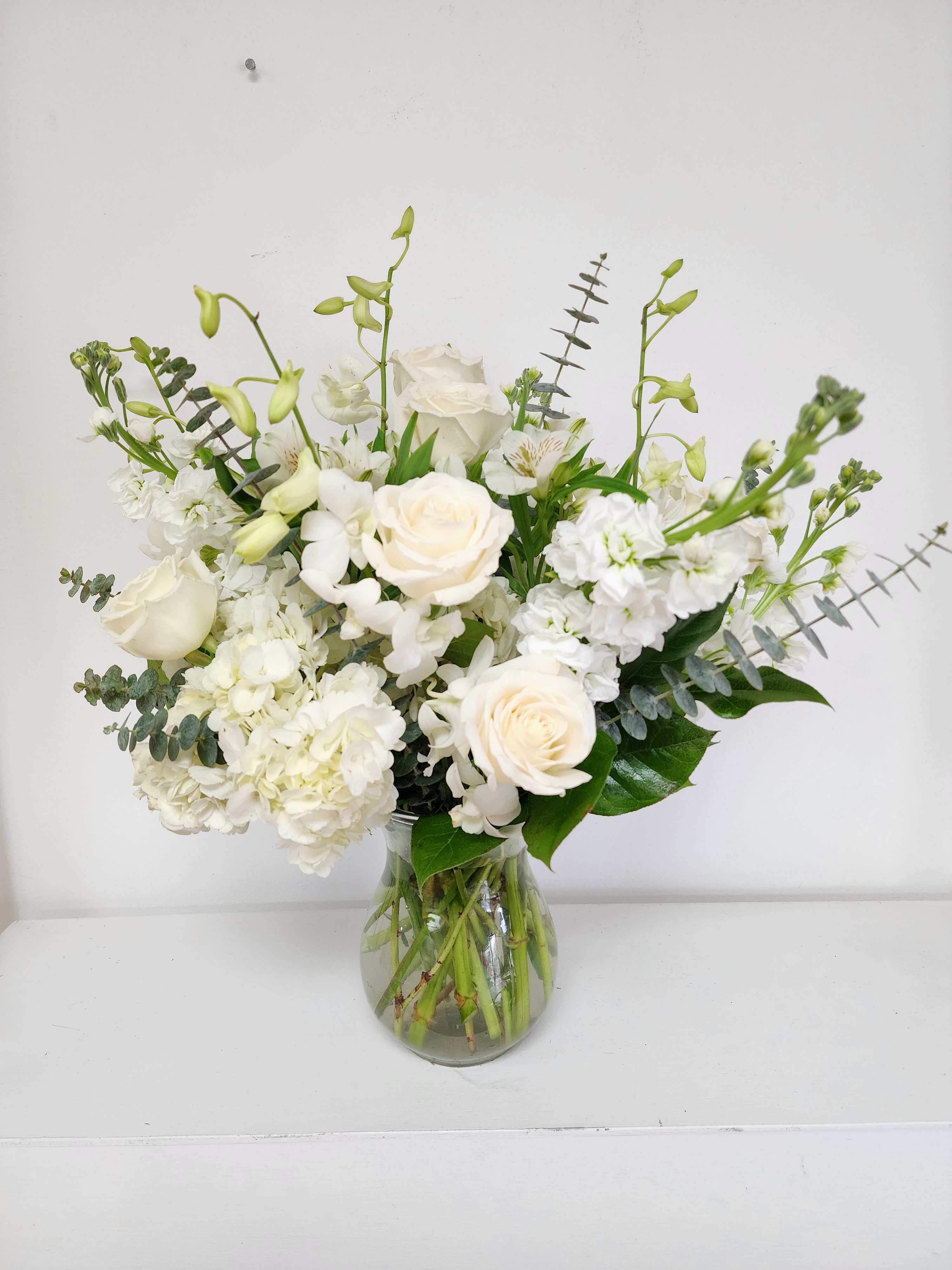 White floral arrangement in a clear glass vase