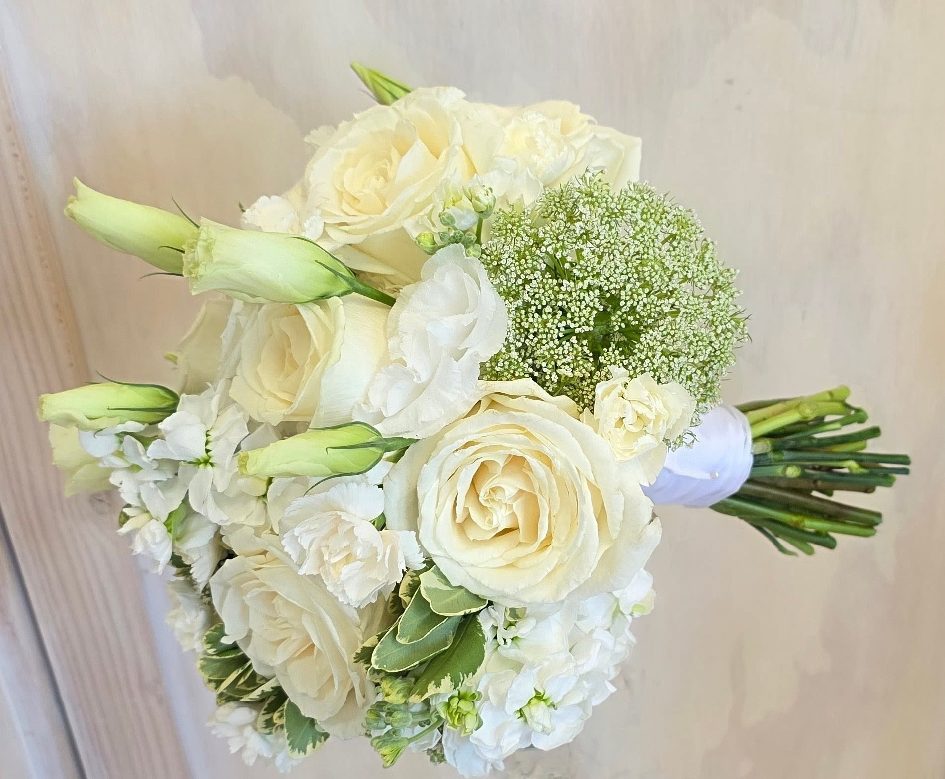 Designers Mix Elegant Bridal Bouquet - An elegantly style mix of all white florals such as roses, baby roses, lisianthus, stock flower. Our designer will choose the blooms and create a perfect beautiful bouquet. perfect for any formal event including proms, weddings, and debutante balls.  Available in other colors as well.