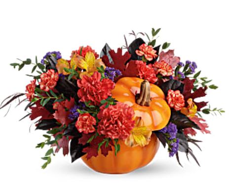 Hauntingly Pretty Pumpkin Bouquet - Add a hauntingly beautiful touch to your fall festivities with this magnificent mix of autumnal alstroemeria and carnations, gathered in a glazed ceramic pumpkin that's sure to be an annual décor favorite! This bouquet features orange alstroemeria, dark orange carnations, miniature orange carnation, purple sinuata statice, parvifolia eucalyptus, red agonis, and lemon leaf. Delivered in Teleflora's Trick &amp; Treat Pumpkin. 