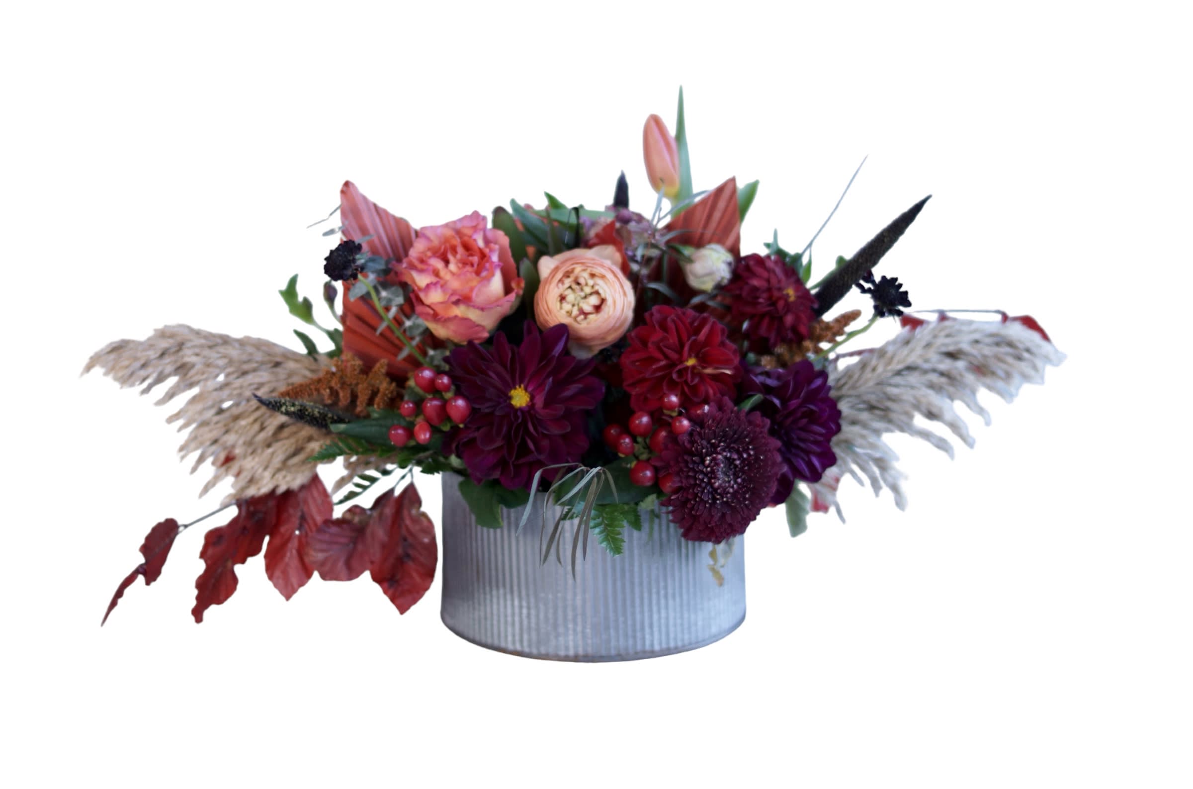 Autumn floral arrangement in a ribbed metal container with burgundy and peach blooms