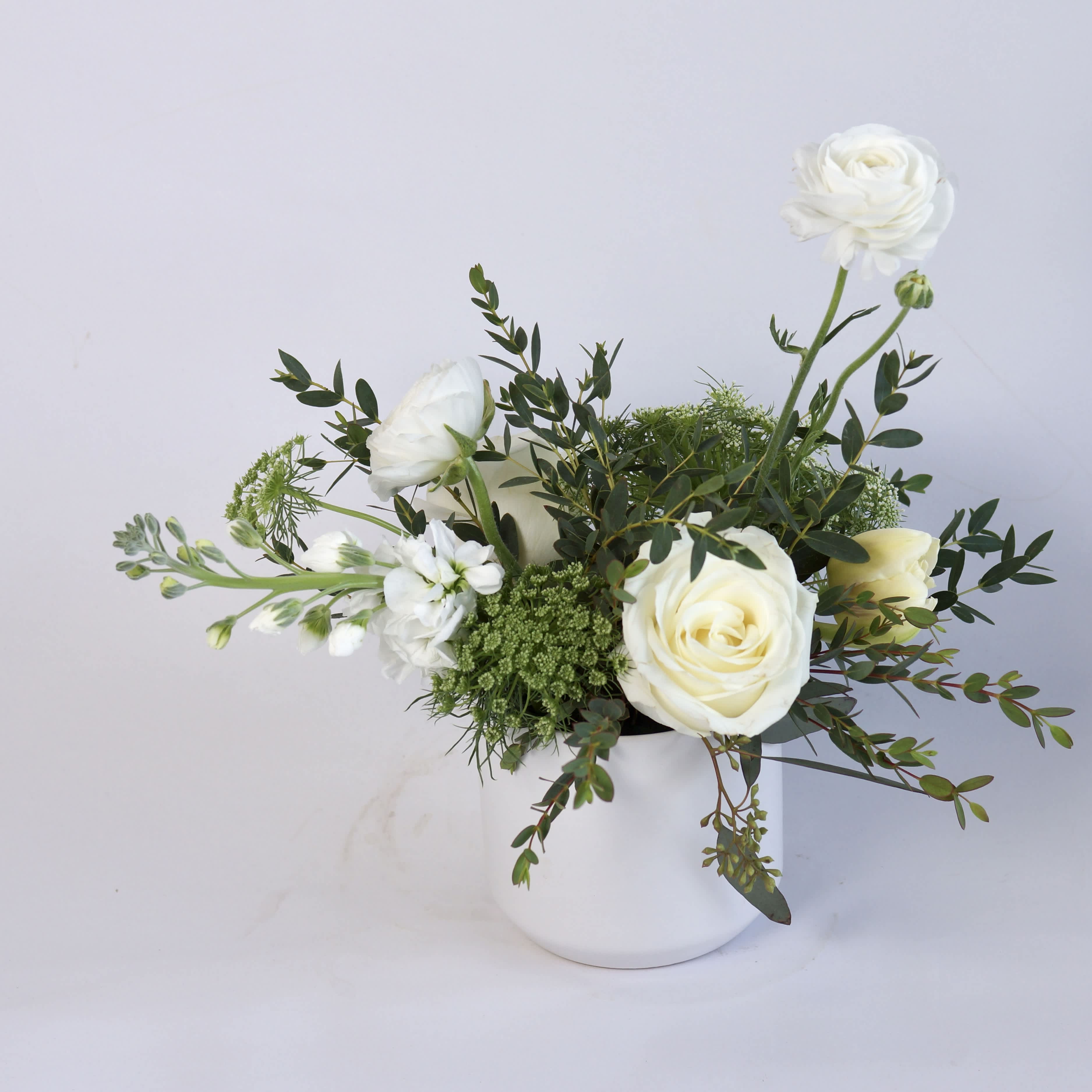 Simple Beauty - Sometimes it’s the simple things! This beautifully made flower arrangement consists of a few blooms, but makes a statement in its monochromatic charm
