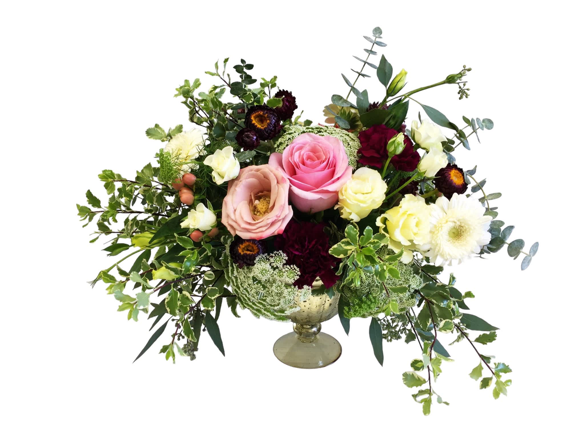 Wedding bouquet with pink, cream, and burgundy flowers in a glass compote vase