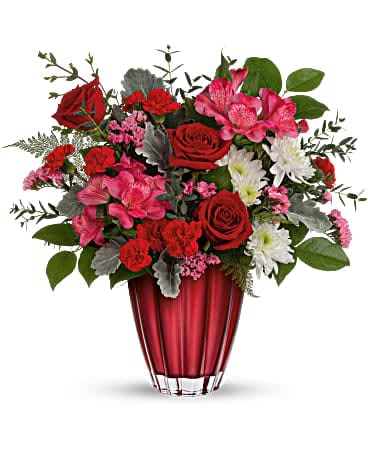 Red and pink mixed bouquet in a red glass vase