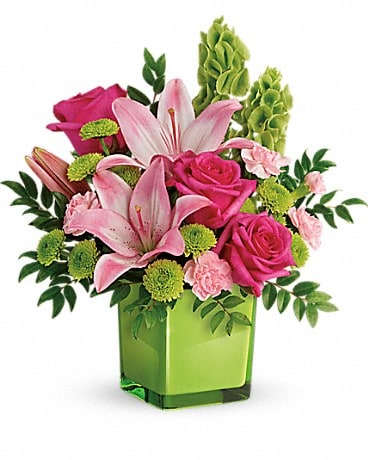Pink lilies and roses in a green square vase