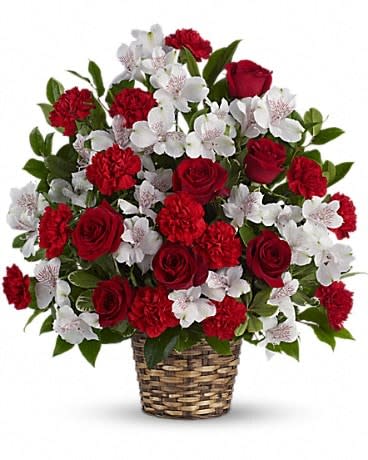 Red roses and white blossoms in a woven basket