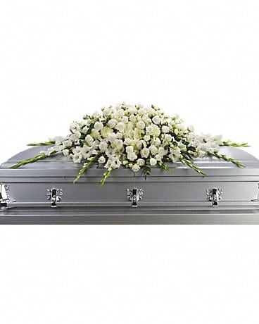 White floral spray on a silver casket