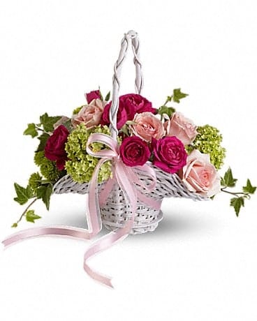 Basket of pink and red roses with green hydrangeas and a pink ribbon