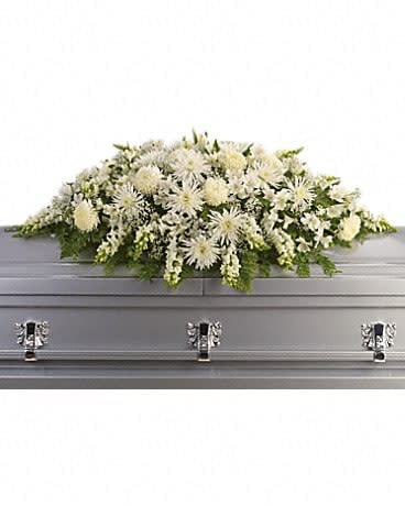 White floral casket spray on a silver casket