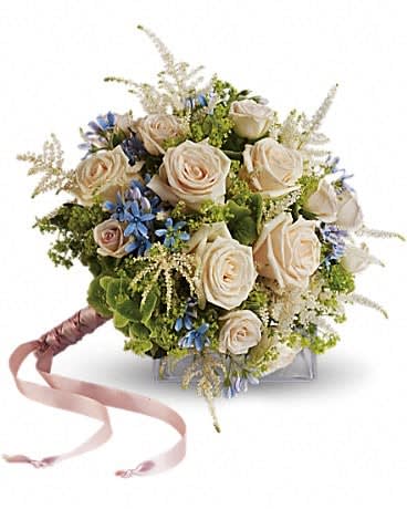 Bouquet of cream roses with blue accents and a pink ribbon handle