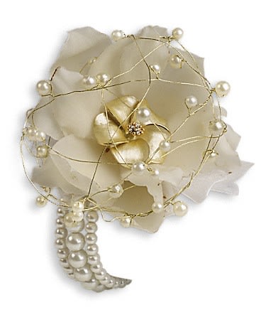 White floral corsage with pearl accents and gold wire