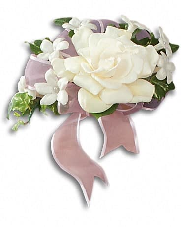 White rose corsage with small white flowers and pink ribbon