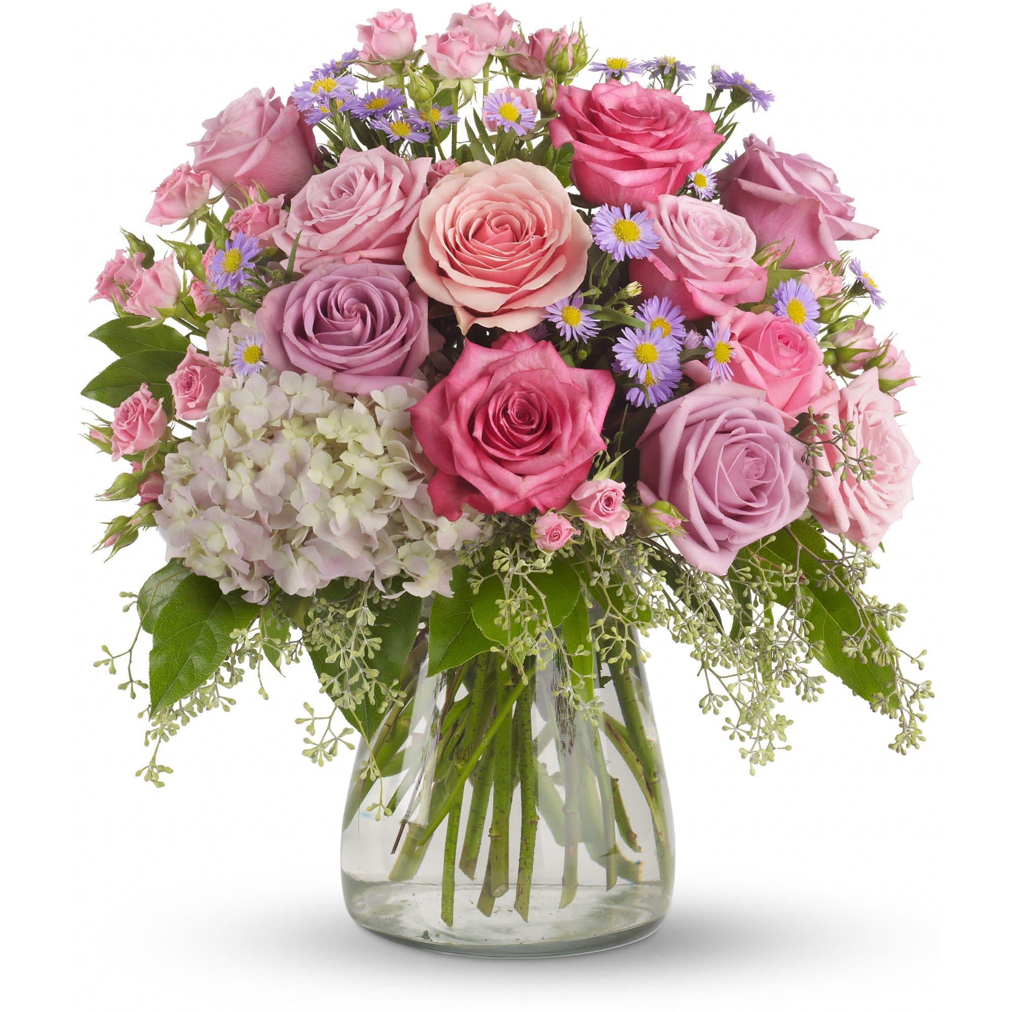 Your Light Shines by Teleflora - This softly elegant gesture of condolence and affection honoring the memory of a life well lived is a gentle touch during a difficult time.  Lavender and pink flowers such as roses, hydrangea, monte cassino asters, eucalyptus and salal are arranged in a clear glass hurricane vase.  Approximately 15 1/2" W x 17" H  Orientation: All-Around      As Shown : T253-3A  
