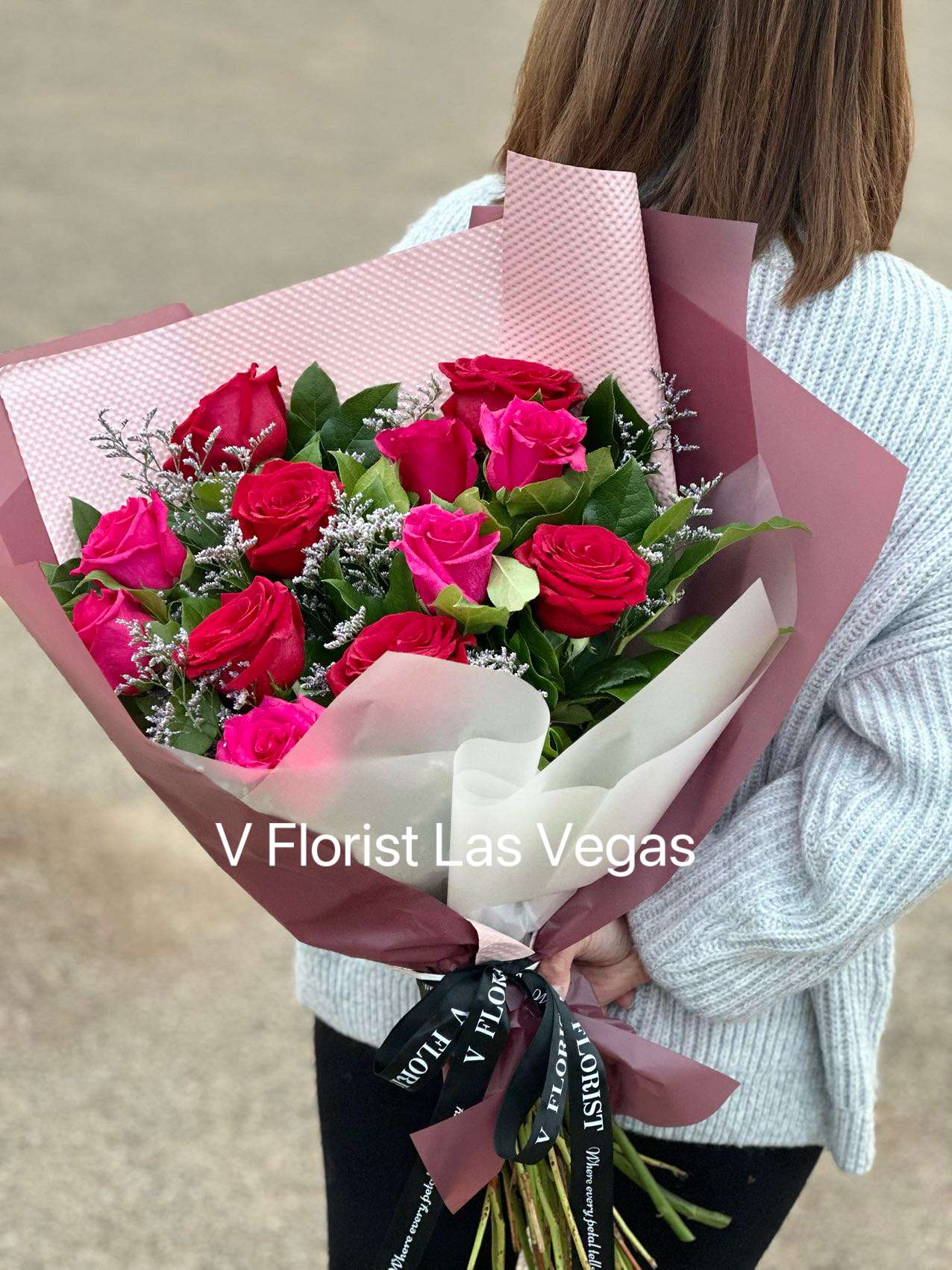 Deluxe Hot Pink and Red Rose Wrapped Bouquet - Hot pink roses and red roses with misty blue in our famous style bouquet. Best for an elegant date night or any special occasion with your loved one.  Our florists select the freshest flowers available, so colors and varieties may vary due to local availability.