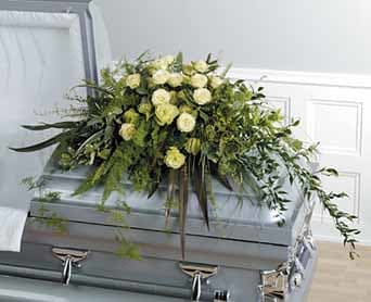  Classic Casket Spray - A beautiful and classic mix of seasonal green, white and cream blooms.   Please Note: Design may not look exactly like what is pictured. Will vary due to floral availability and artistic interpretation. 