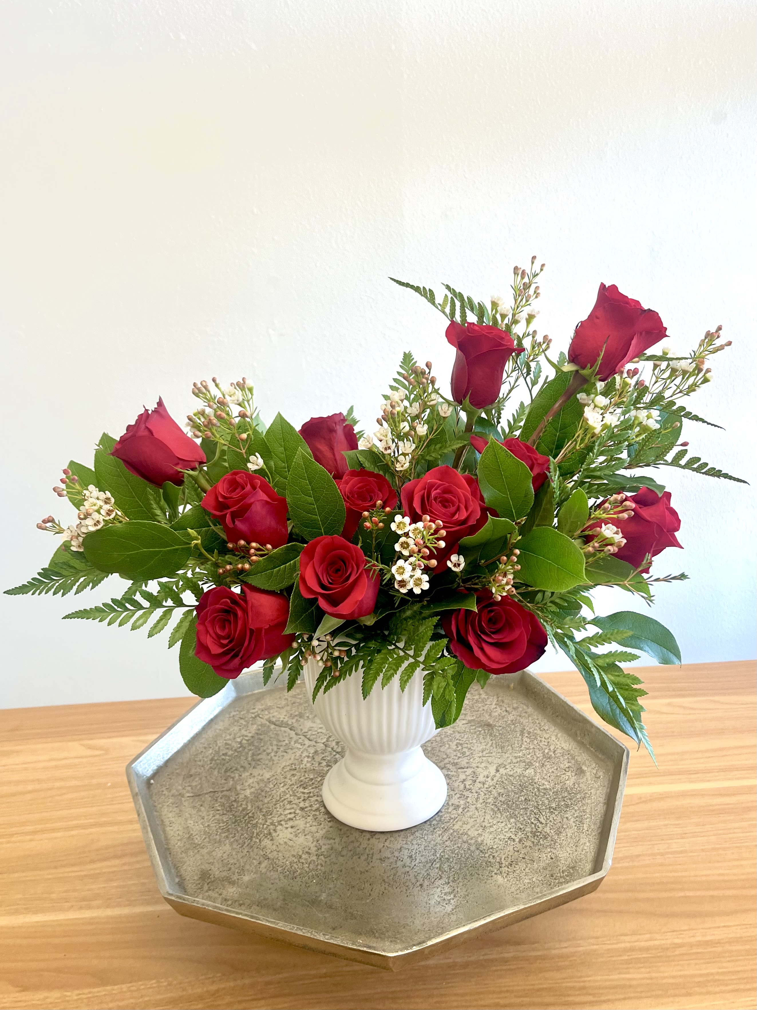 Dozen Roses in a Vase - Premium long stem red or pink roses and luscious fresh greenery beautifully arranged in a glass vase. Actual vase used will vary depending on availability.  Call shop for details or specific requests.