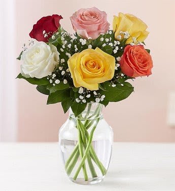 Bouquet of multicolored roses in a clear glass vase