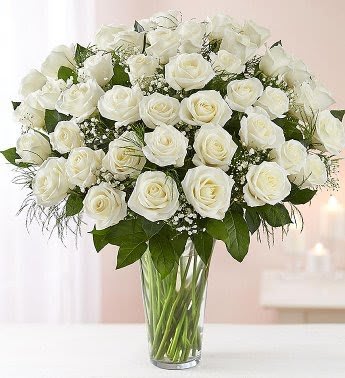 Ultimate Charm 4 Dozen White  - Our striking long stem white roses are the ultimate way to show you care. These pure white blooms are artistically arranged by our expert florists inside and elegant vase and personally hand delivered to help you express how you feel straight from the heart. 