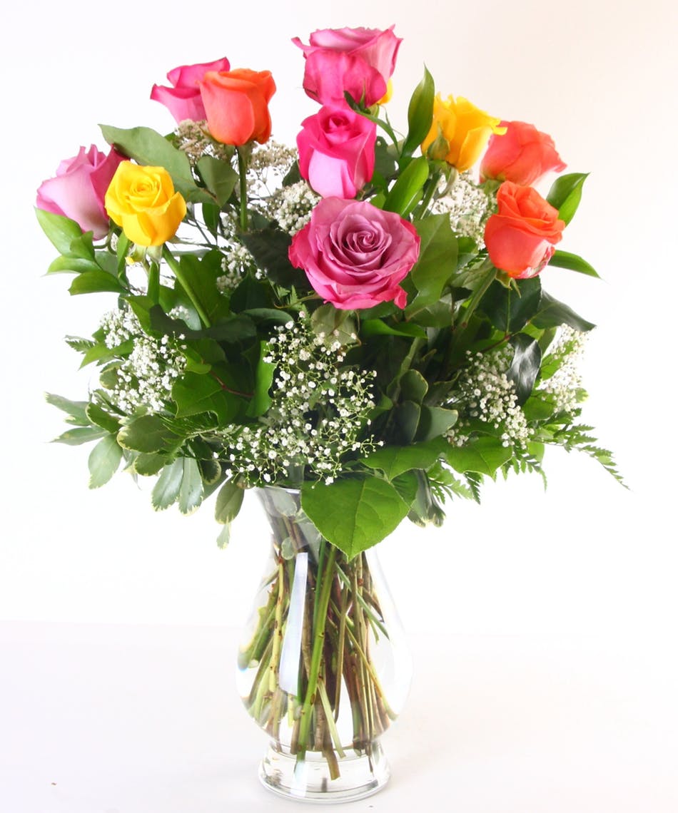 Bouquet of multicolored roses in a clear glass vase