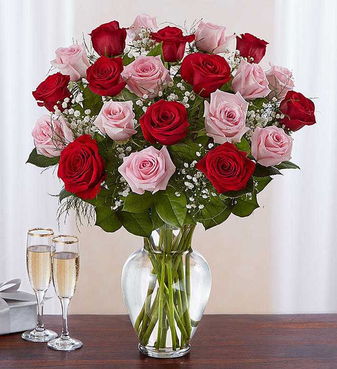 Bouquet of red and pink roses in a clear glass vase