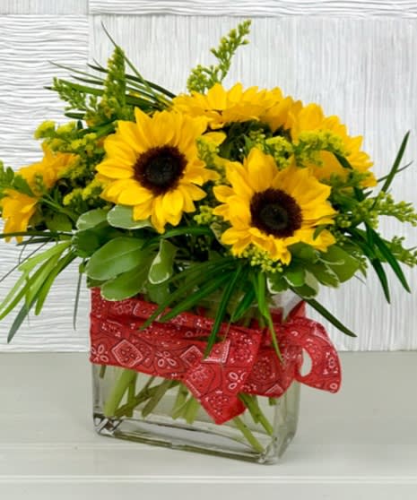Southern Sunflowers - These gorgeous sunflowers would brighten anyone's day! Featuring yellow sunflowers, lush deep greens and yellow filler in a clear glass cube, this arrangement is perfect for any occasion. Whether it be a "Get Well Soon," "Thinking of You," or a just because gift, this beautiful bouquet will surely bring a smile to your loved one's face.