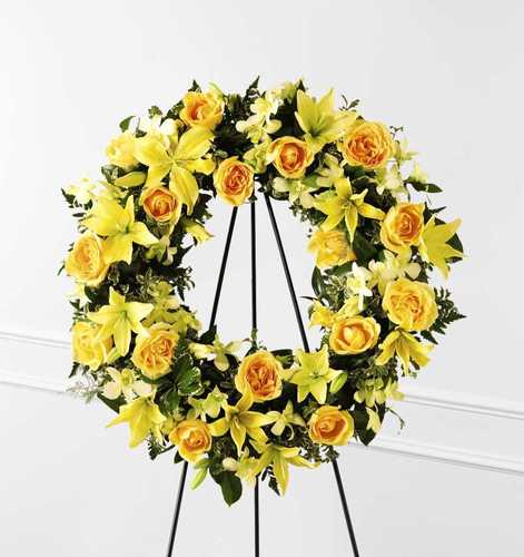 Golden Wreath Standing Spray - A striking floral tribute of golden blossoms in a classic funeral wreath design that symbolizes hope and eternity. This standing sympathy wreath includes roses, Asiatic lilies, Alstroemeria, or similar assorted fresh flowers. Appropriate for wakes, funerals, and memorials. With this yellow wreath you will bring hope and some joy for these difficult times. Let us gather the best flowers to show an expression of your friendship and sympathies.