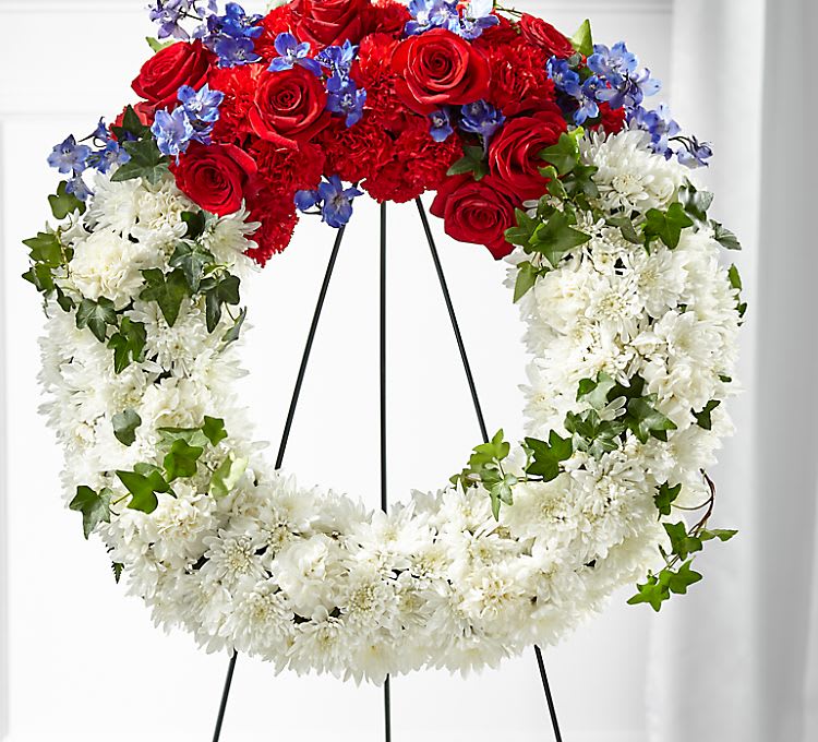 Red white and blue wreath - White with cluster of red Roses, loving tribute created with roses,  Chrysanthemums, carnations For comfort love and sympathy  Flower girls delivers to all Tulsa funeral homes Dyer's, Butler Stump and dyer, Reynolds Mark Griffith, Heath Griffith, Nine's, Fitzgerald, Moores, Mallory, Serenity, advantage, Teel-SCHAUDT'S,  Leonard marker, Bigelow, Jack's, Stanley Same day Tulsa flower delivery