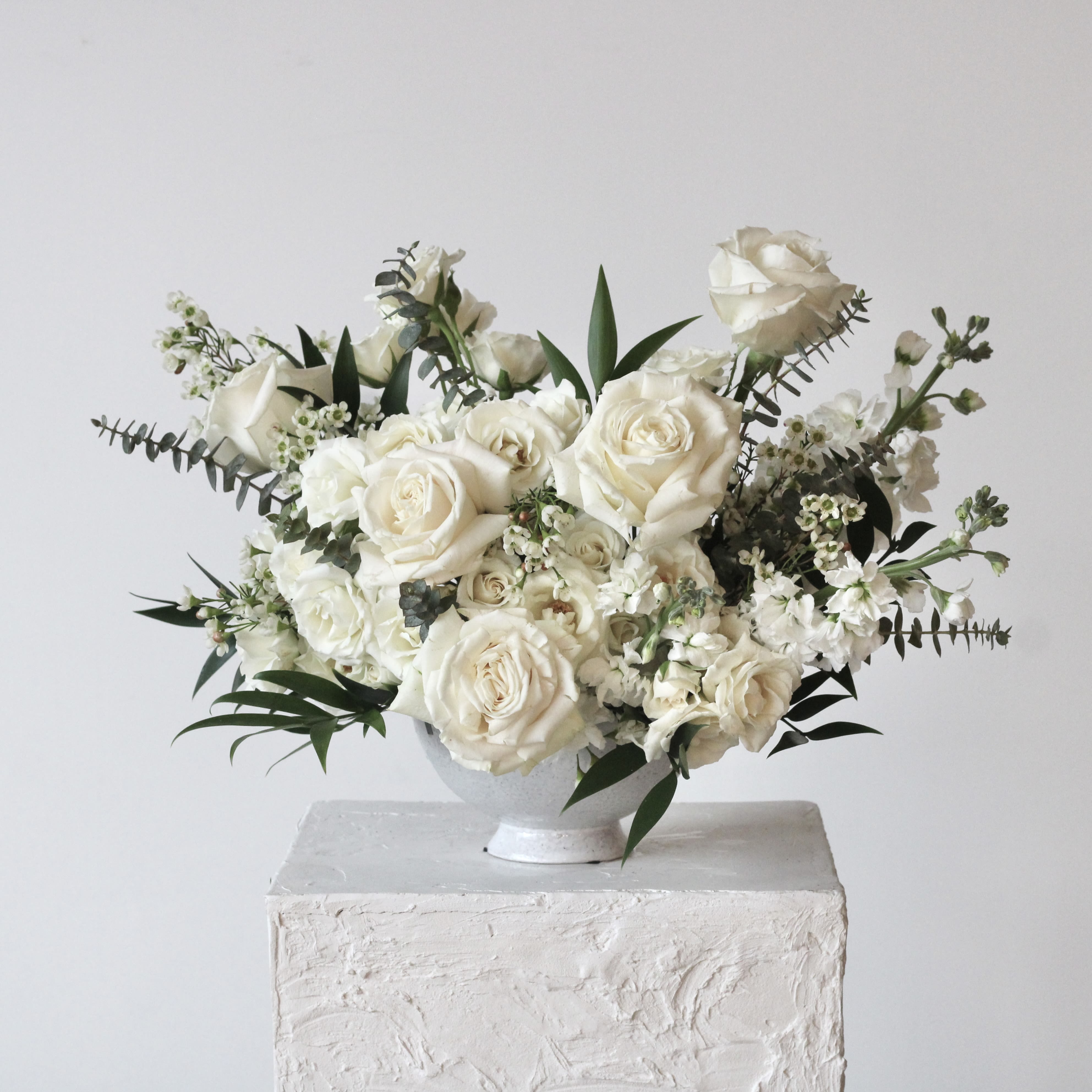White rose bouquet in a white vase