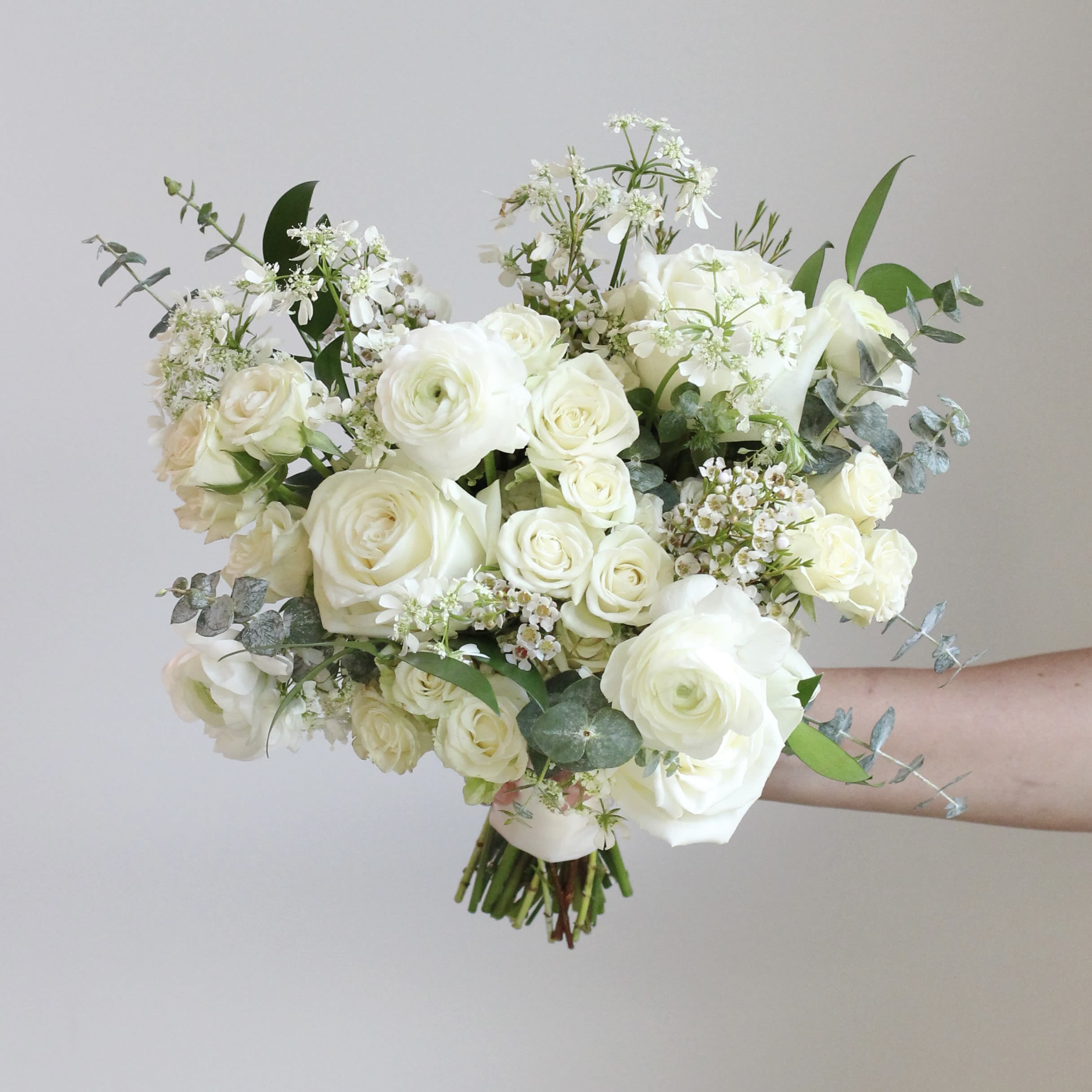 White rose bouquet with airy filler flowers and eucalyptus