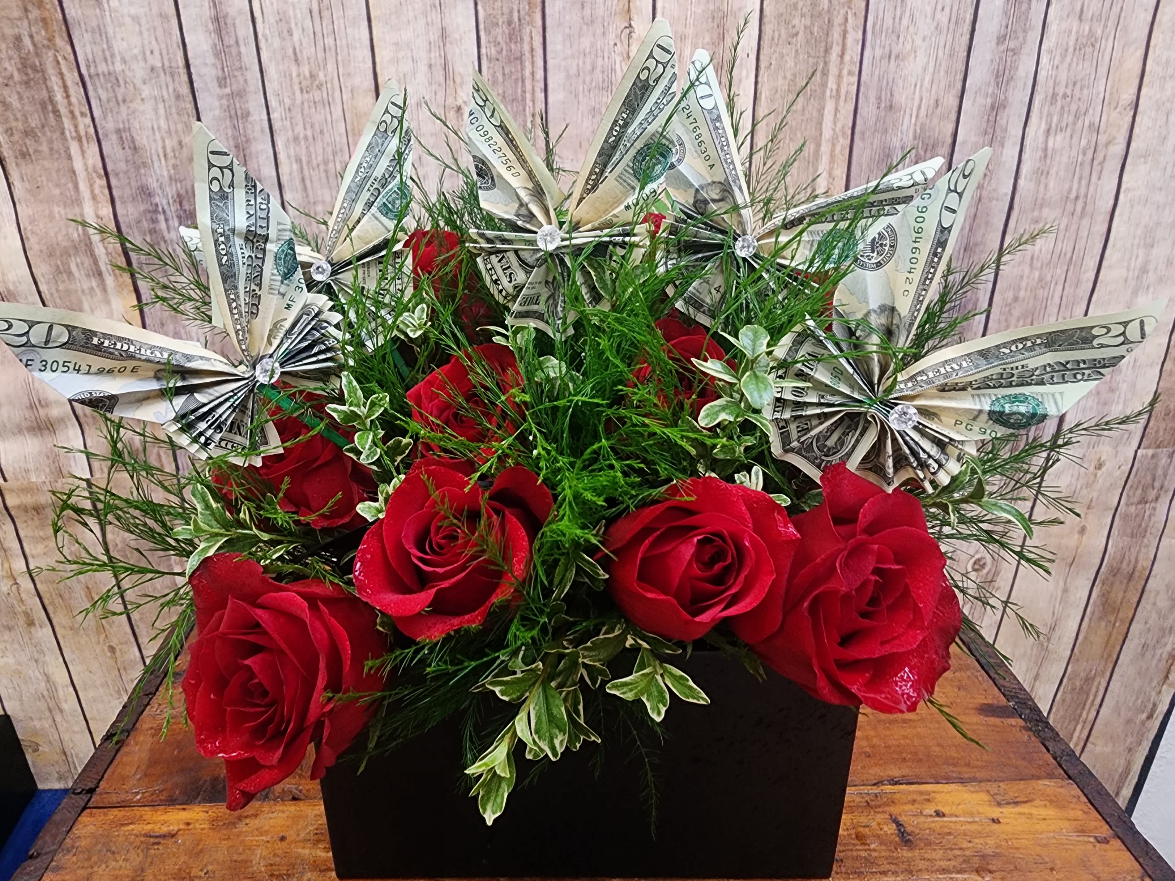 Red roses with dollar-bill paper flowers in a black box