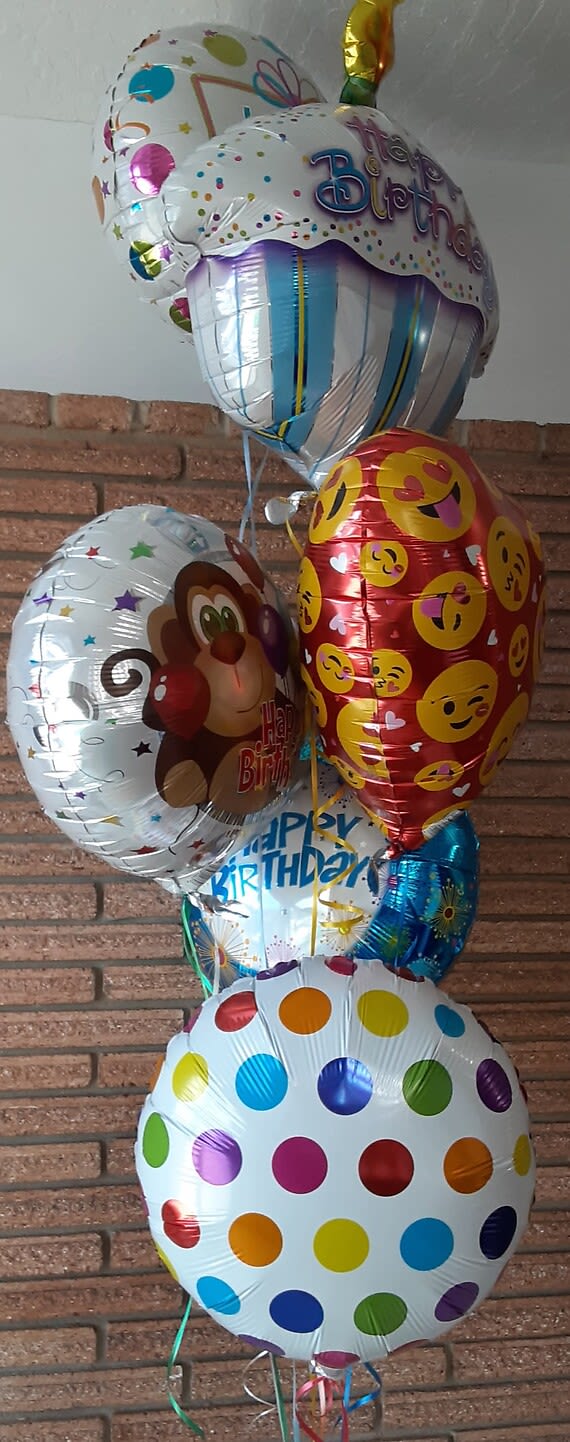 Cluster of birthday balloons with colorful polka dots and emoji designs