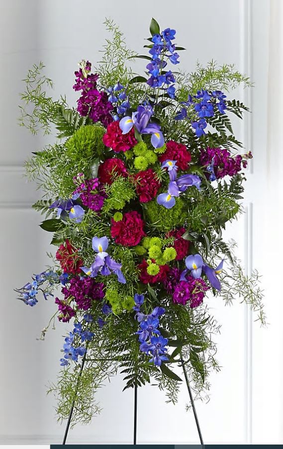 Tall standing floral spray with blue, purple, and pink flowers