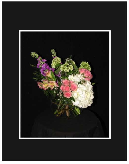 Bouquet of pink, white, and purple flowers against a black background