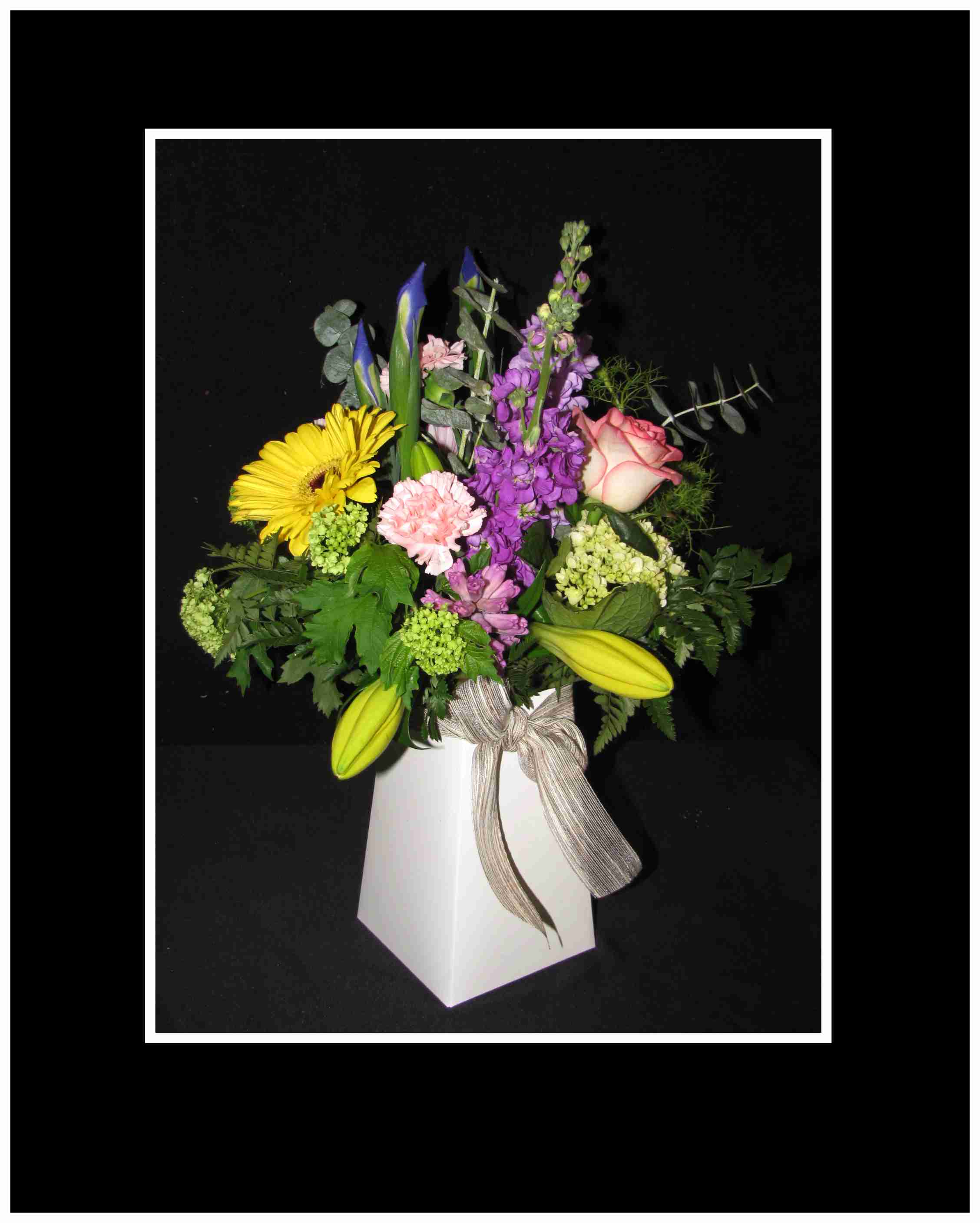 Mixed bouquet in a white box vase with a ribbon bow