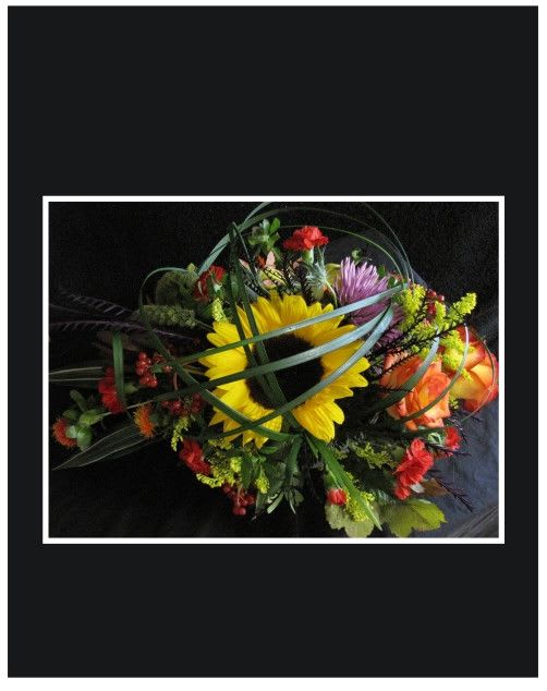 Sun Burst Bouquet - Sun flowers and roses create a touch of sunshine for any ones home.  Approximately 10" High x 16" long.