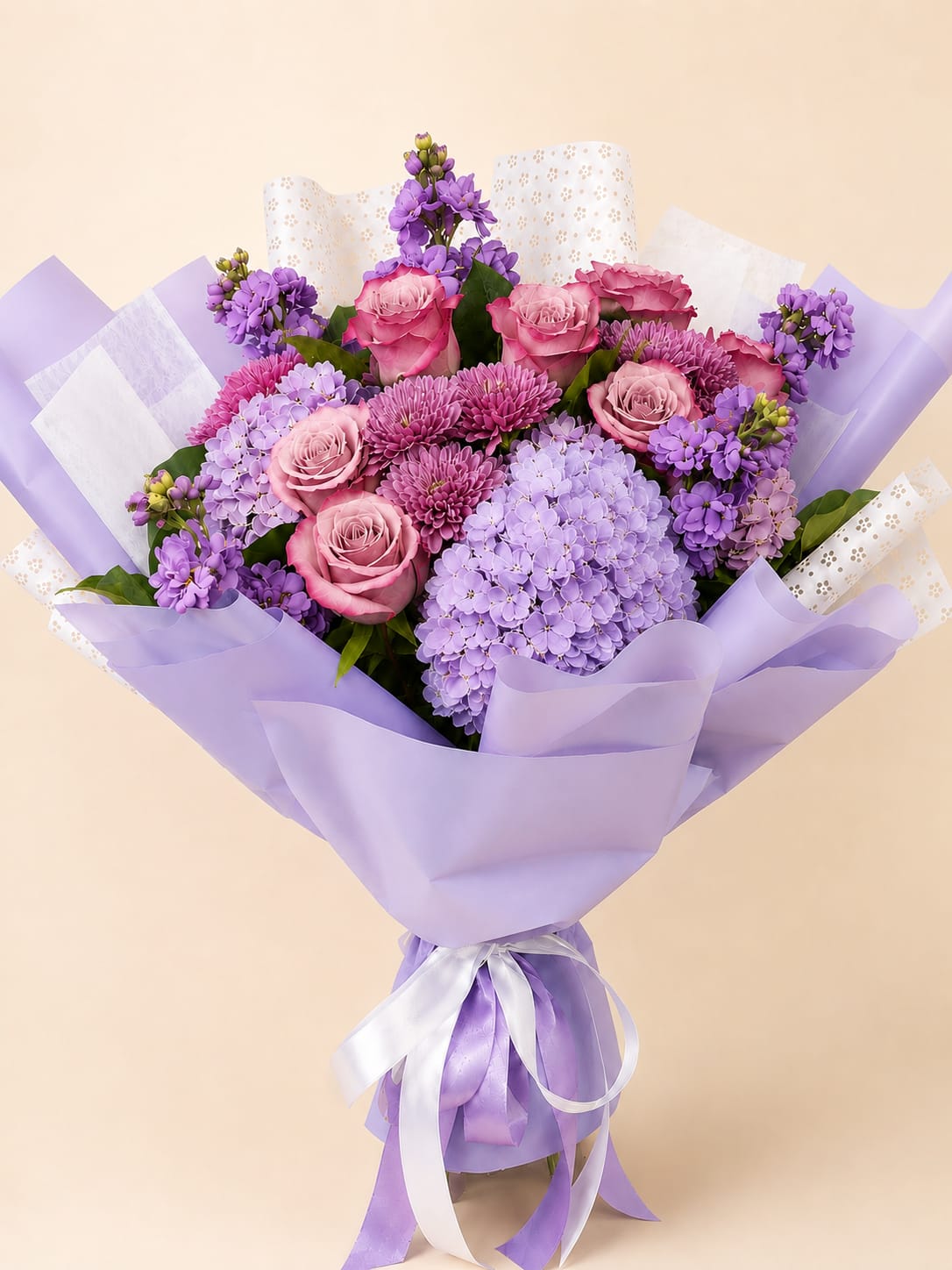 Lavander Dreams - A luxurious hand-tied bouquet featuring premium roses, pastel purple hydrangeas, chrysanthemums, and fresh stock, wrapped in elegant lavender paper. A graceful arrangement perfect for birthdays, anniversaries, or celebrating life’s special moments. 