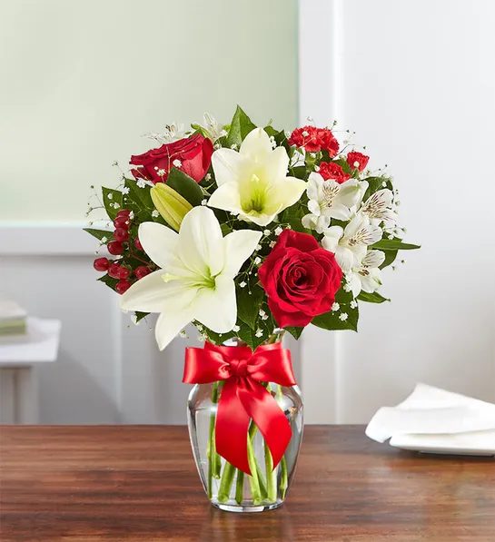 Fields of Europe Christmas - That feeling of bliss, captured in a bouquet. Inspired by the beauty of the European countryside, our best seller brings together radiant roses and lush lilies in a glass vase wrapped in red ribbon. Whatever your reason for reaching out, it’s a gift that delivers on delight.