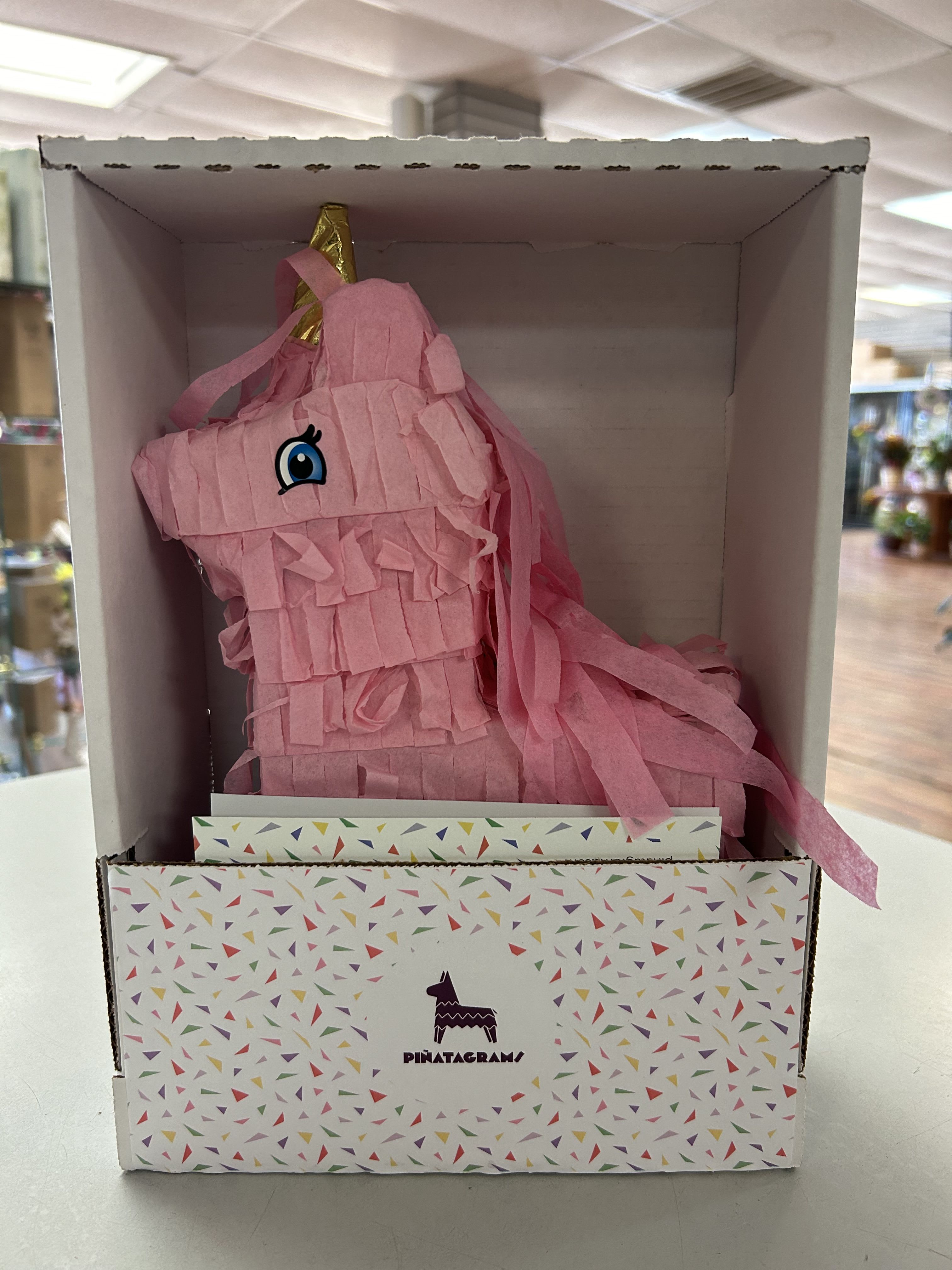 Pink unicorn piñata in a display box