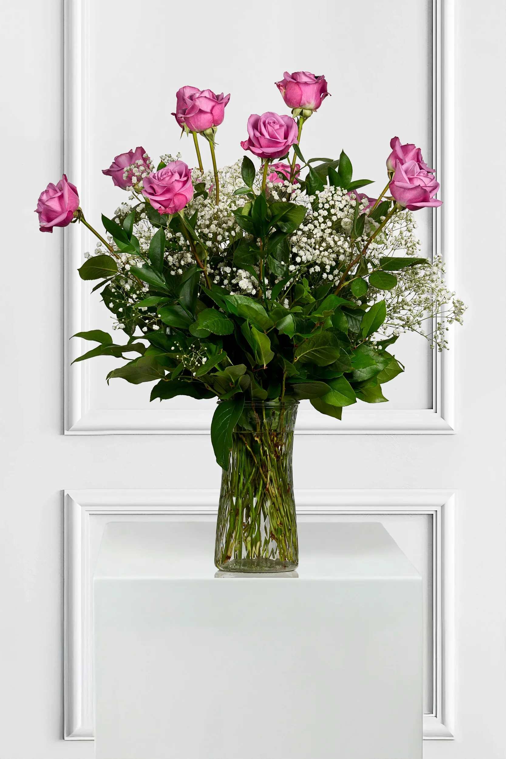 1 Dozen Lavender Roses with Baby's Breath - Vivid lavender roses form a beautiful bouquet designed to make the person you're thinking of feel truly cherished. This flower arrangement for birthdays, love and romance, or a thoughtful "thinking of you" gift also works beautifully for Mother's Day-its classic color combo reads both celebratory and intimate, the kind of bouquet that says "you matter" without words.  Perfect for sending to a mom or close friend, this arrangement arrives ready to display and brighten a room. For best enjoyment, place in fresh water away from direct heat and change the water every 2-3 days to keep the roses looking their freshest.