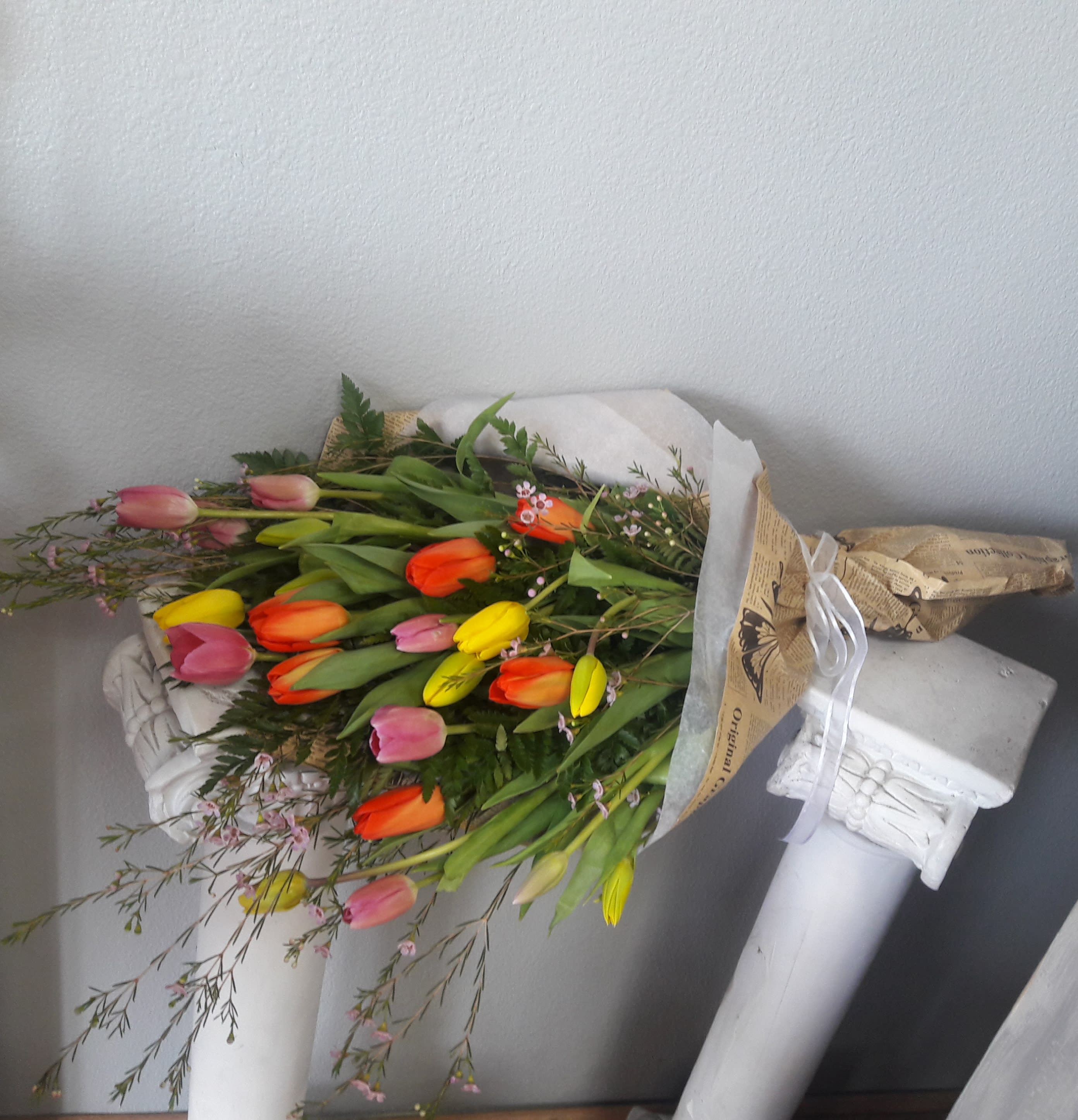 Bouquet of multicolored tulips wrapped in paper