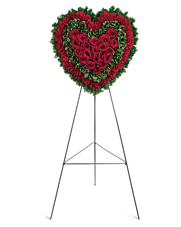 Simply Beautiful - Speak from your heart. This funeral display is a charming, heartfelt way to express your love, composed of sympathy red roses and carnations with variegated pittosporum and fern. 