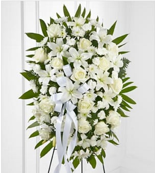 The Exquisite Tribute Standing Spray - The Exquisite Tribute Standing Spray is an elegant display of sweet serenity. White roses, Asiatic lilies, chrysanthemums, and mini carnations are artfully arranged amongst emerald palm fronds and lush greens. Accented by white satin ribbon and standing on a wire easel, this standing spray is an outstanding way to honor the life of your loved one. BETTER spray is approximately 33"H x 21"W. Your purchase includes a complimentary personalized gift message.