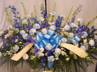 Large blue and white floral spray with ribbon bow